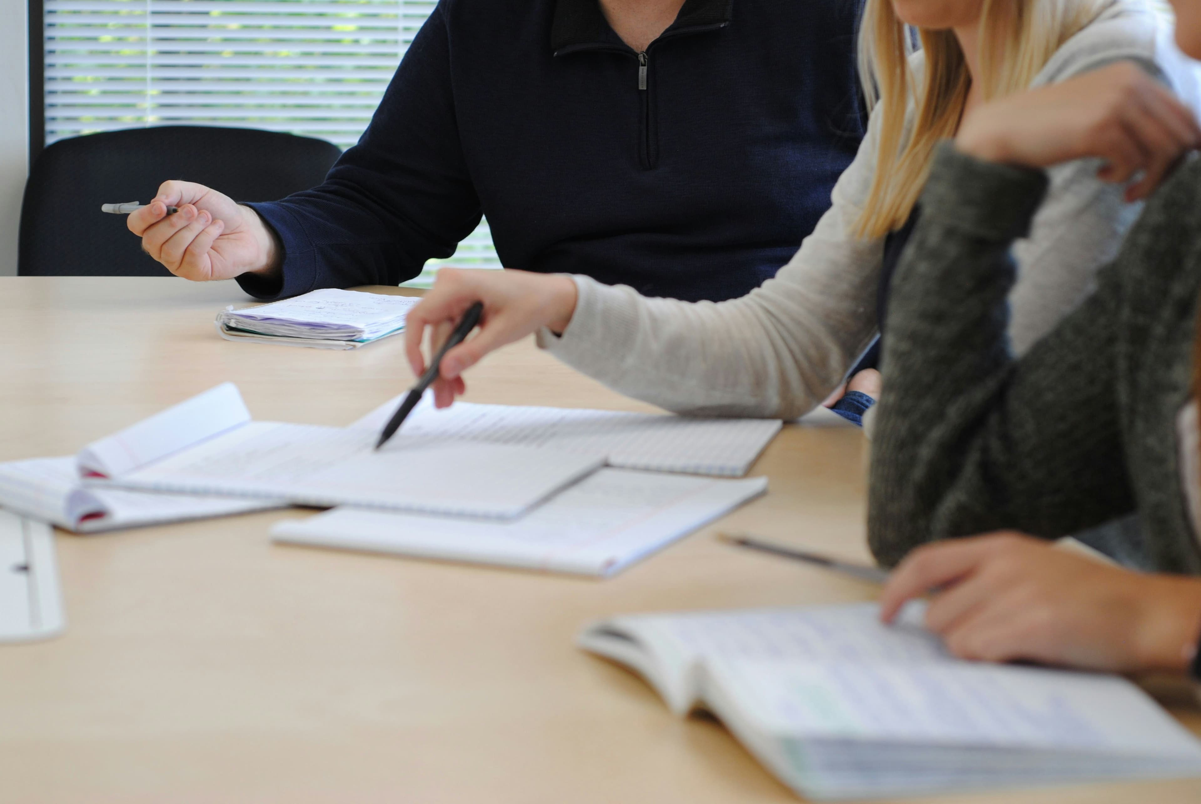 Advisors reviewing notes and documents together at a table