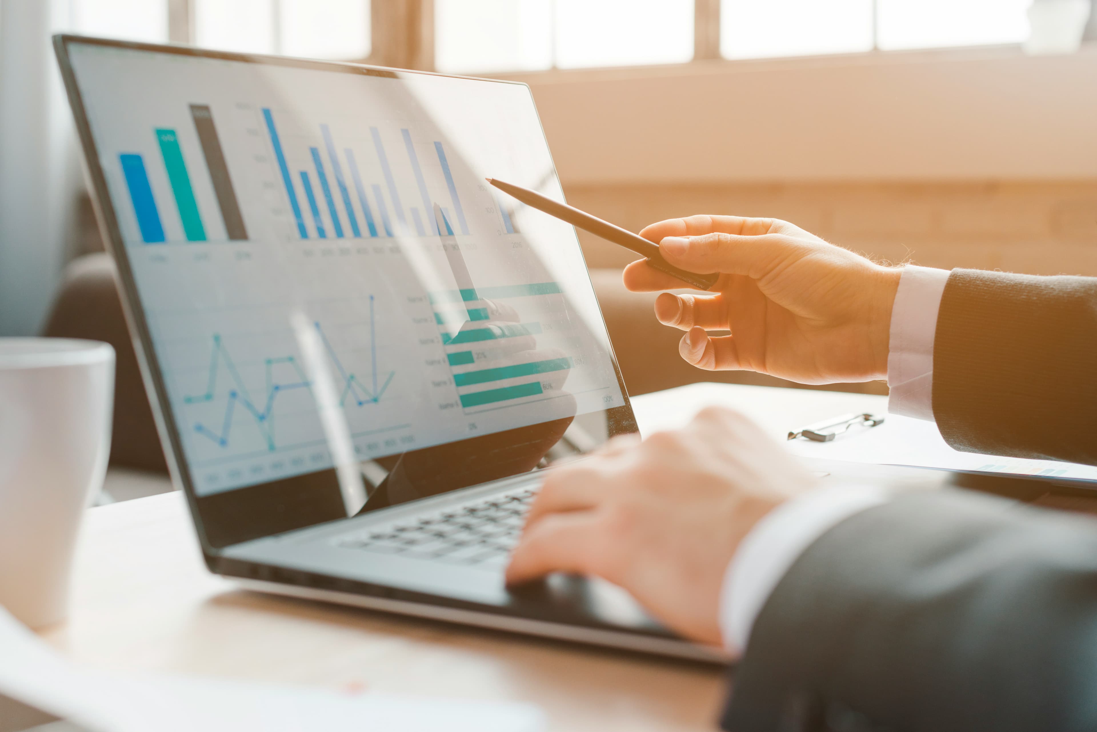 Close-up of a person reviewing financial charts on a laptop